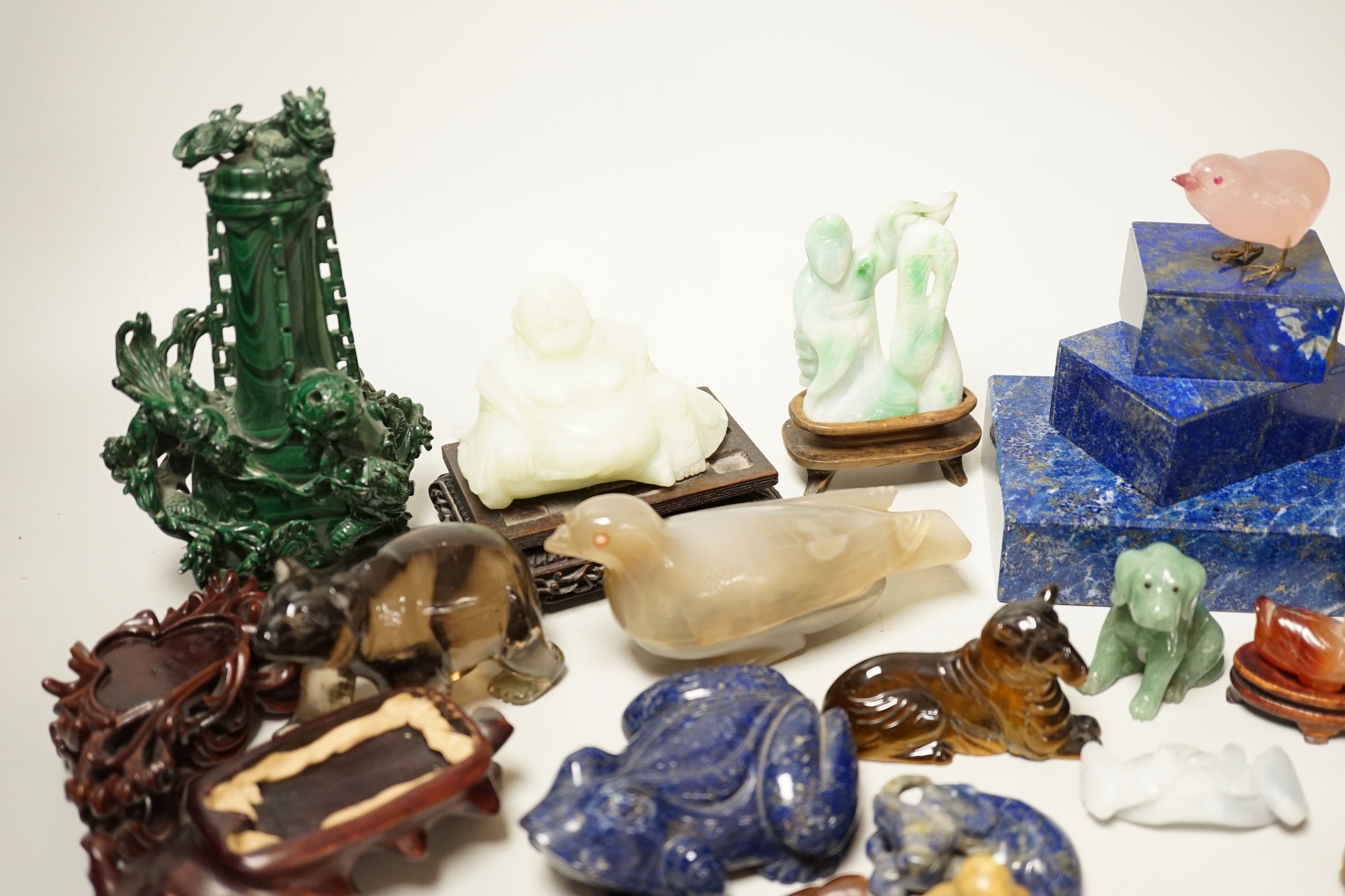 A collection of assorted Chinese hardstone carvings, boxes etc, including a Chinese jadeite carving of a lady, 7.8cm high, wood stand